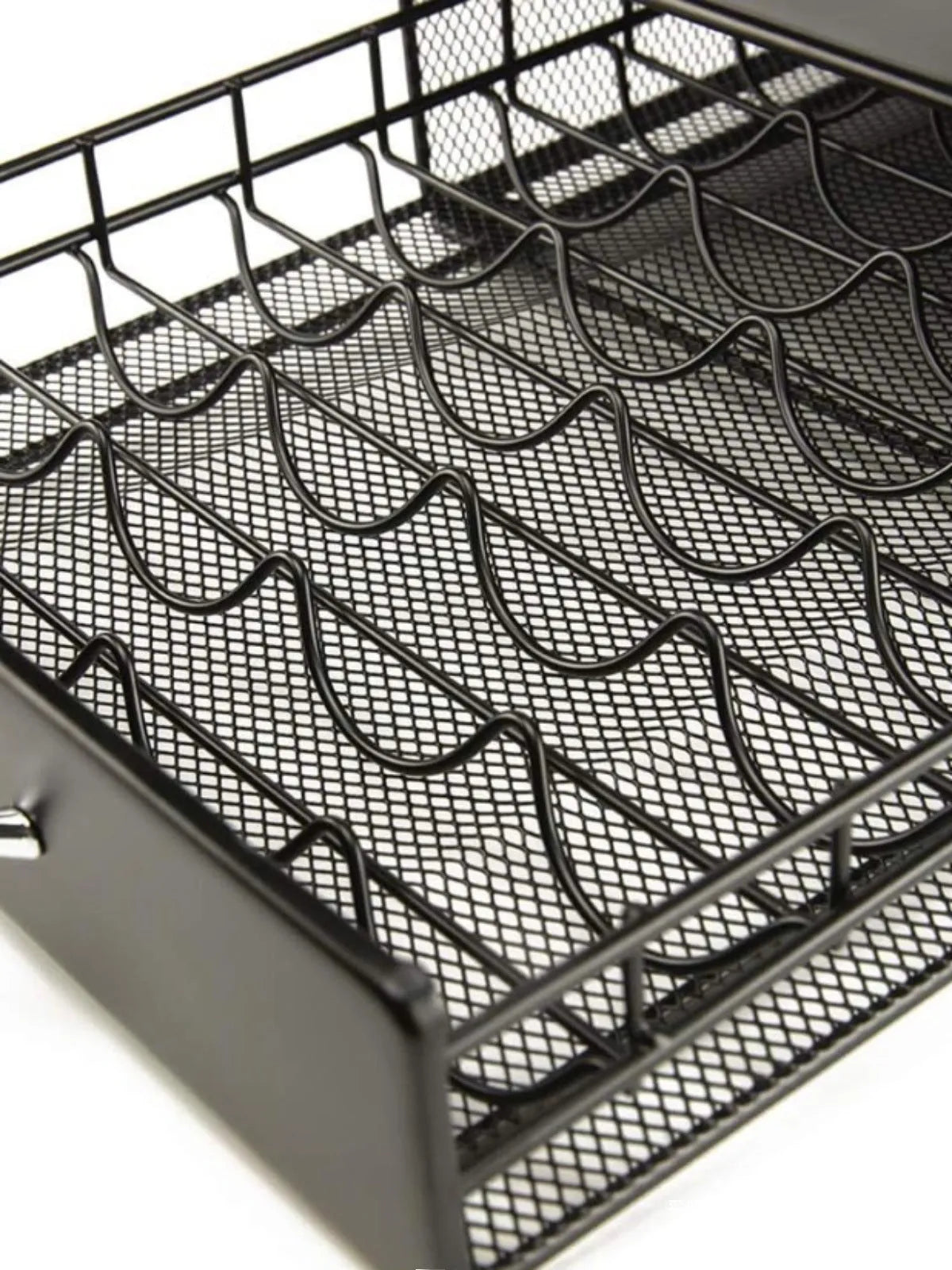 Black coffee capsule storage drawer with silver handle on a cafe countertop
