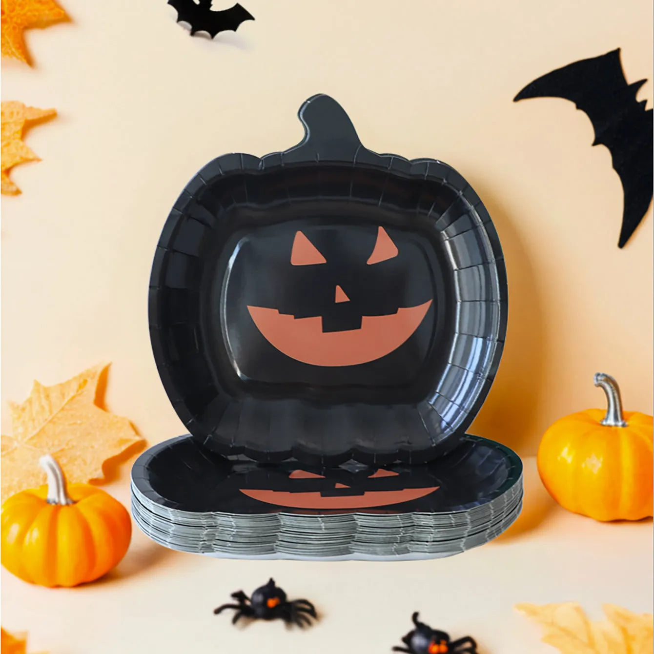 Black pumpkin-shaped disposable paper plates in 9-inch size for Halloween parties