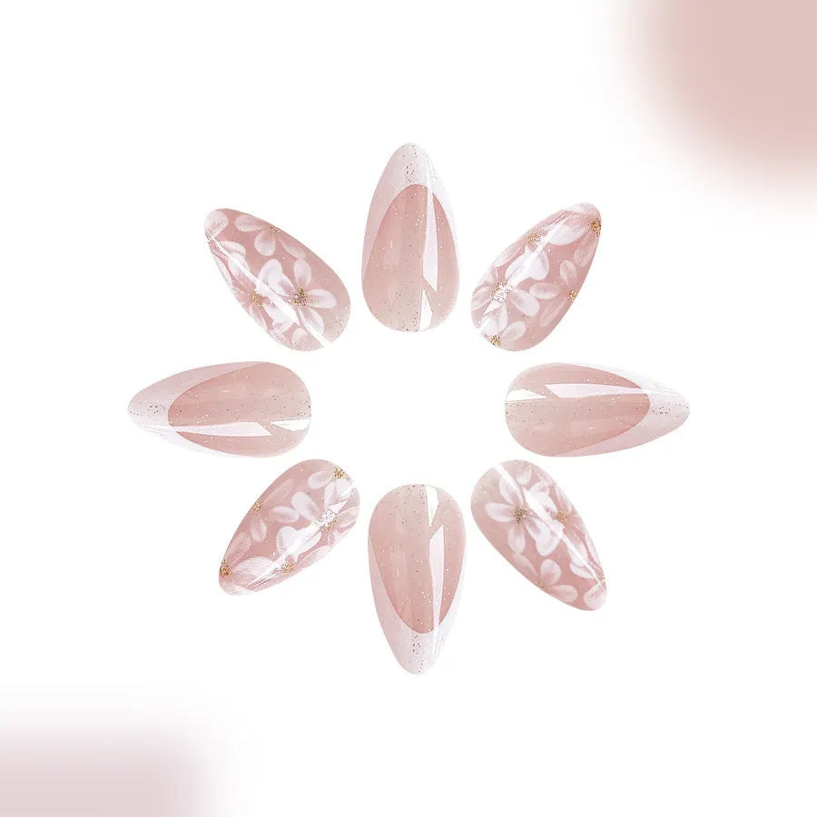 Short almond French style press-on nails with glitter flower decoration in colour C625