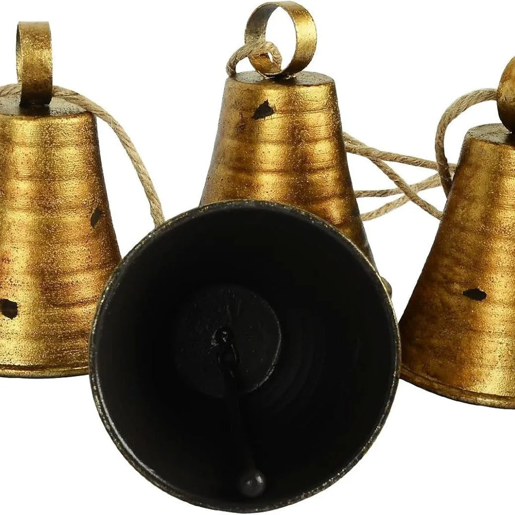 Set of four retro country handmade metal bells in rustic style, each 11.5 x 8.5 cm, on white background