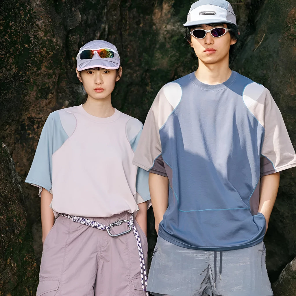 Man wearing a loose fit patchwork t-shirt in a solid colour with short raglan sleeves.