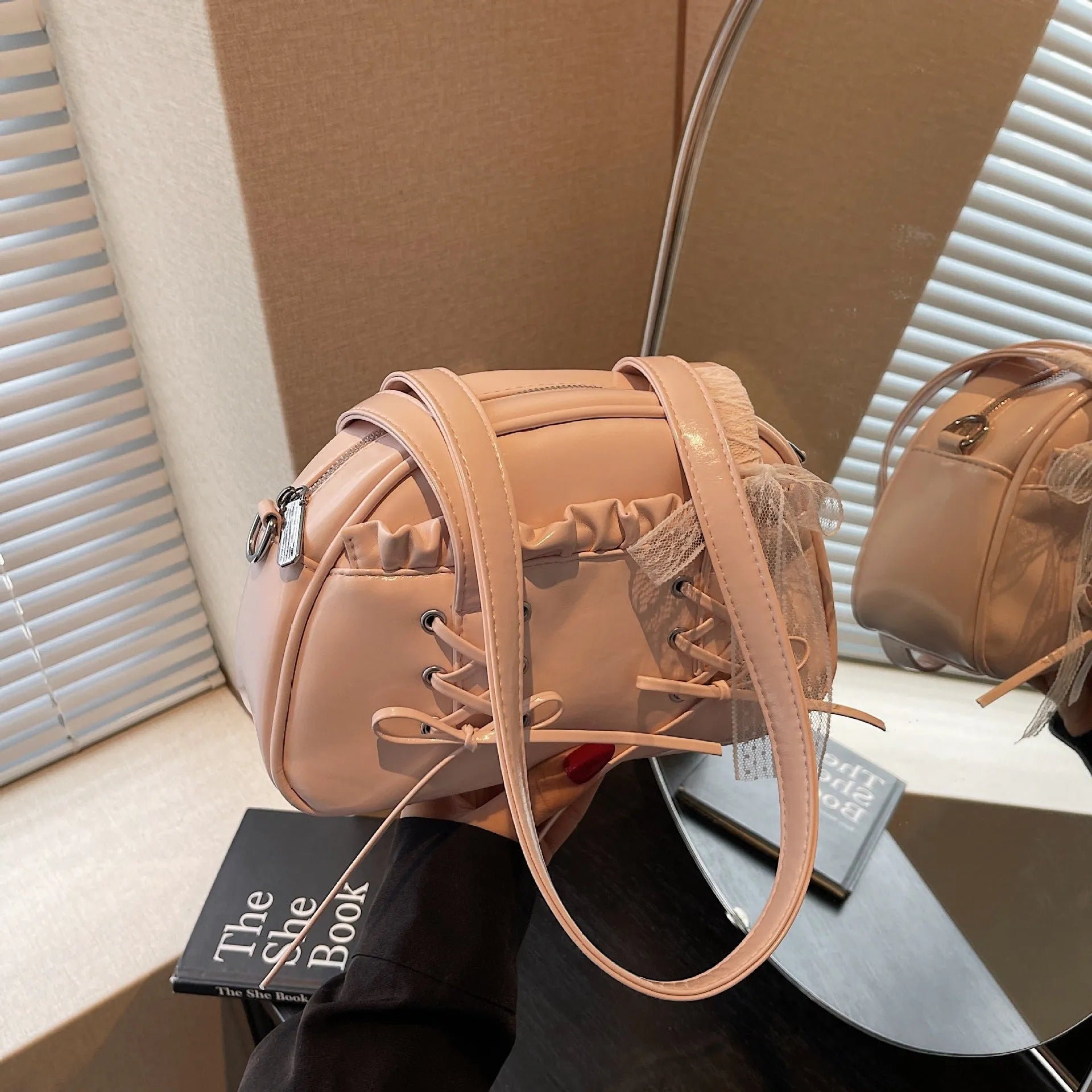 Milky white women's PU shoulder bag with a black bandage bow and sewing thread detail.