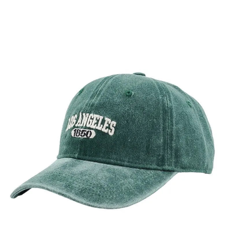 Retro peaked cap with distressed letter embroidery and adjustable sizing in conical crown design