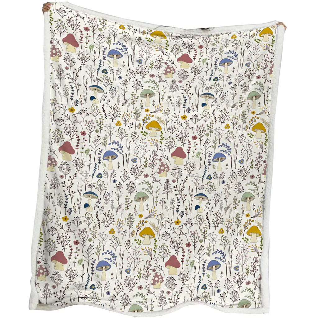 White Sherpa fleece blanket with tree leaf mushroom pattern, sized 130x150cm, on a sofa