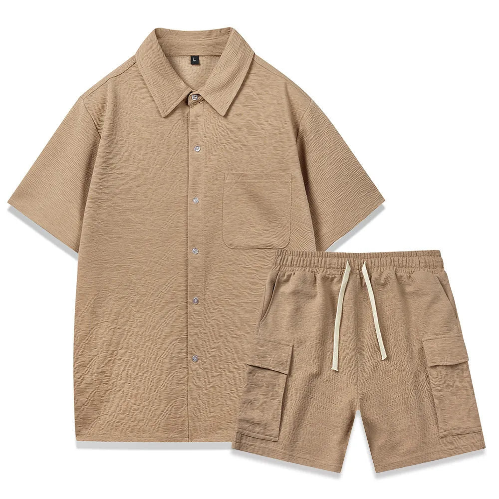 Plain grey polyester two-piece set with short sleeve top and elastic waist shorts laid flat.
