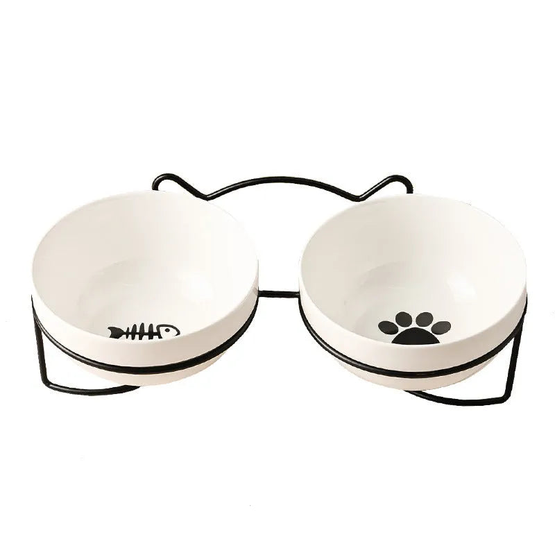 White ceramic cat bowl with cat paw print pattern in a black iron cat-ear frame