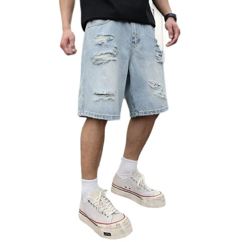 Light blue ripped denim shorts with a loose, straight leg fit and distressed detailing.