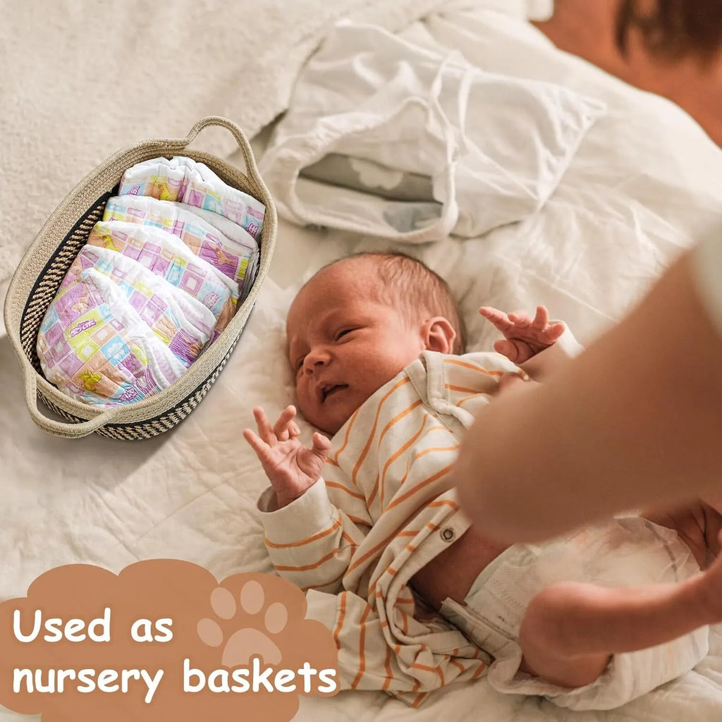 Small light beige handmade cotton rope storage basket with wooden handle on a table.