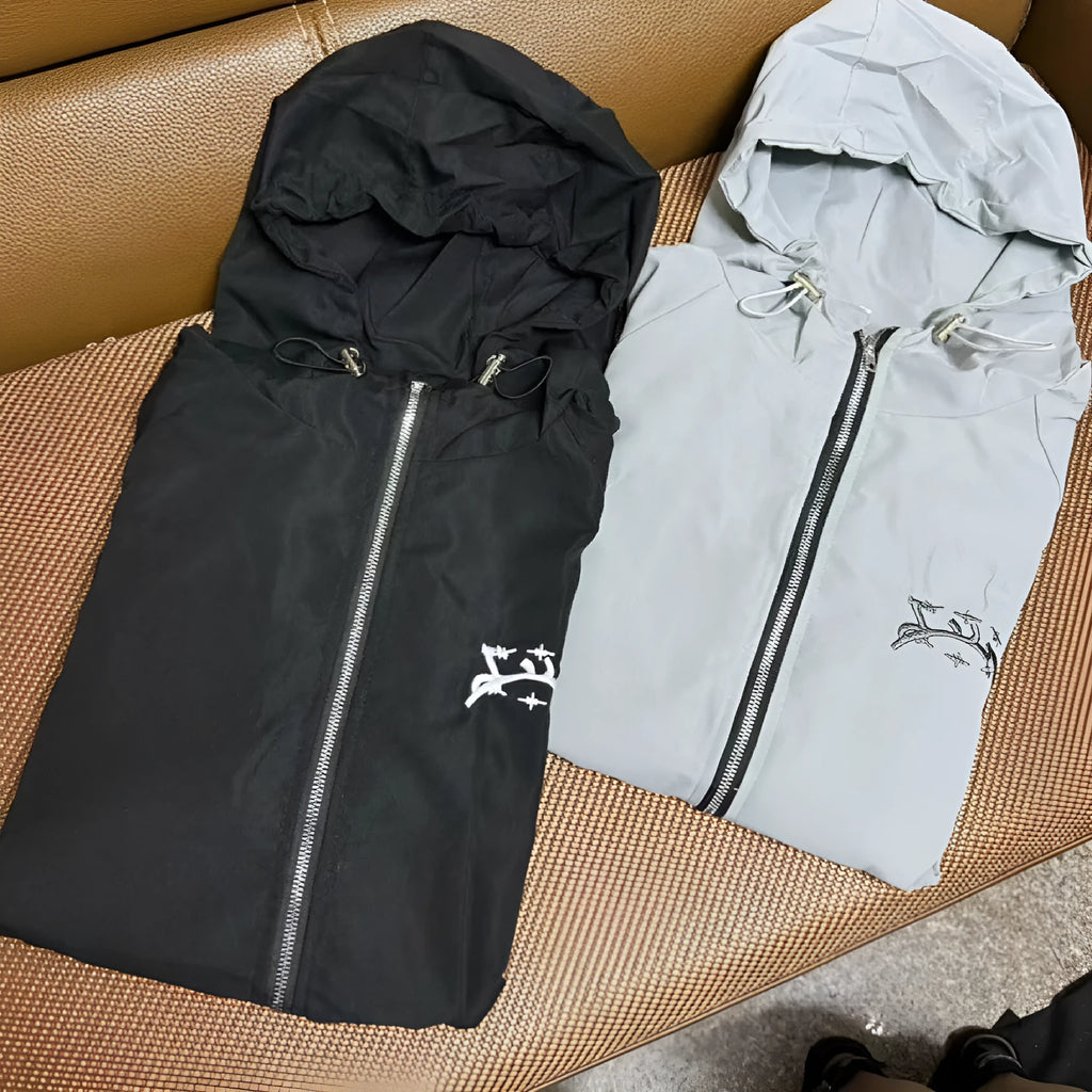 Grey loose-fit men's hooded sunscreen jacket in British style hanging on a hanger.