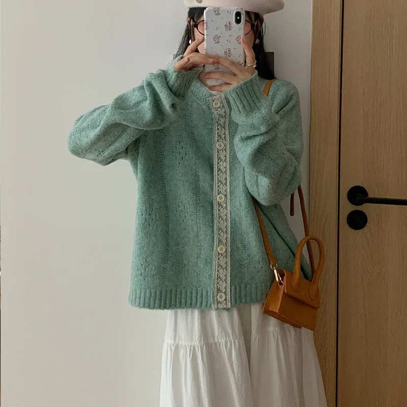Loose apricot-coloured retro-style knit cardigan coat on a hanger