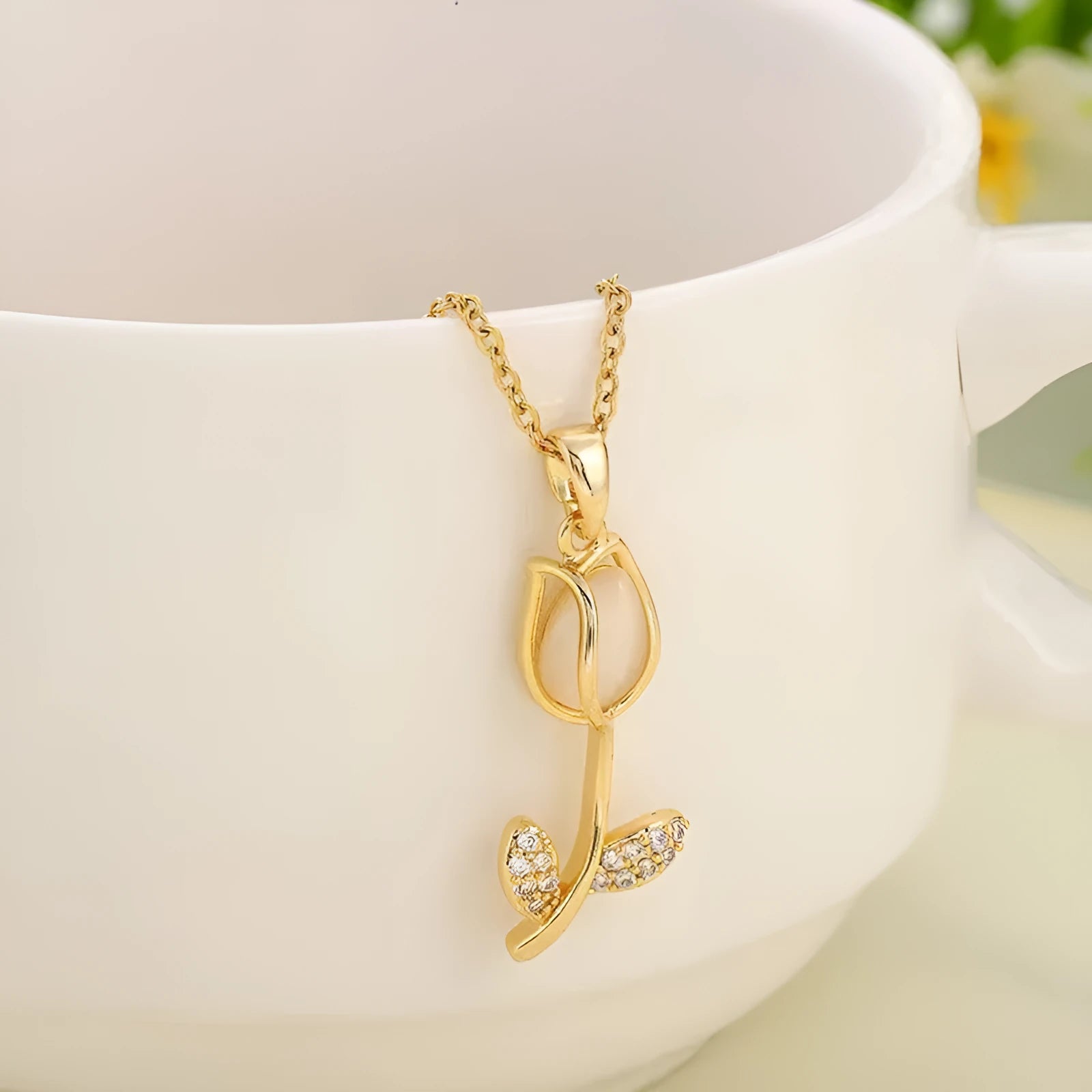 Gold zircon tulip flower pendant necklace on an adjustable titanium steel chain.