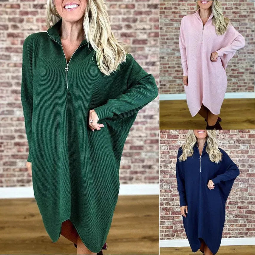 Women's solid colour loose fit knit dress with raglan sleeves on a hanger.