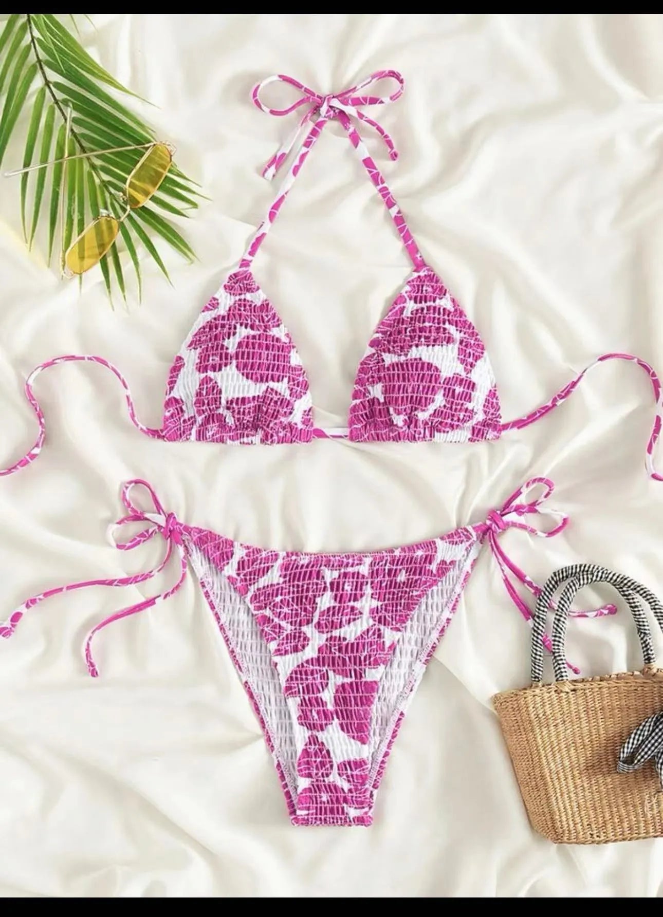 Women's pink floral halter neck swimsuit top and briefs set on a neutral background