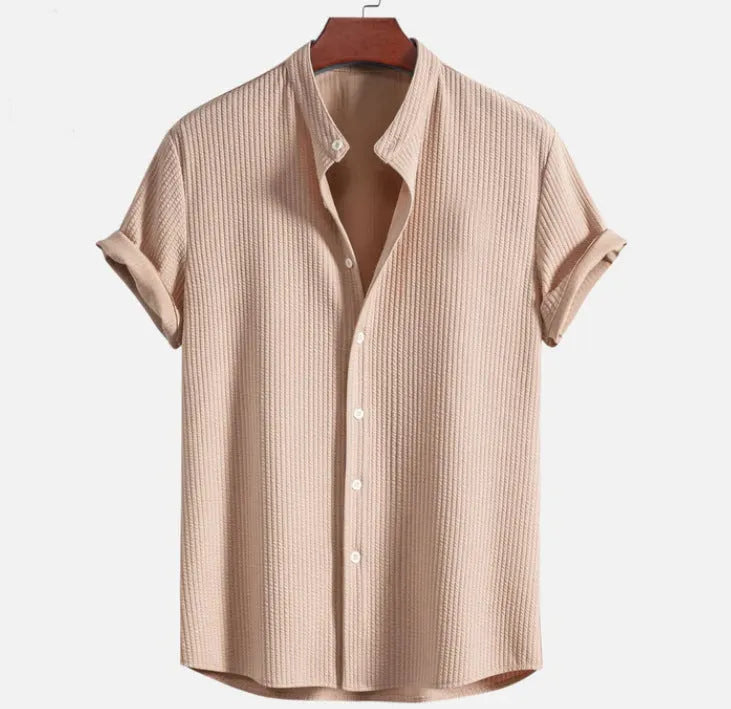 Men's loose fit short sleeve polyester summer shirt on a hanger, shown in a light blue colour.