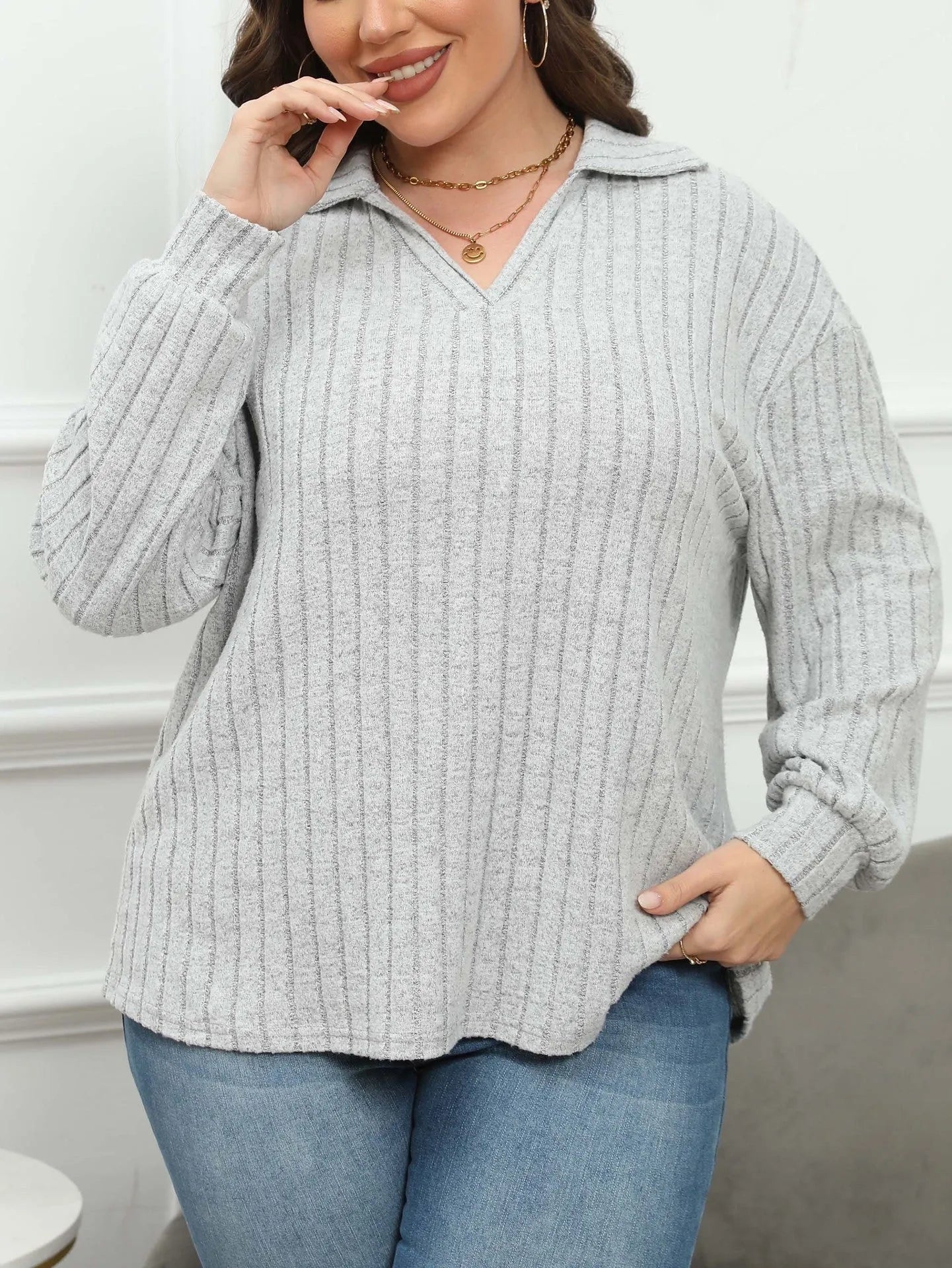 Women's plus size gray fleece pullover with a polo collar and full lantern sleeves.