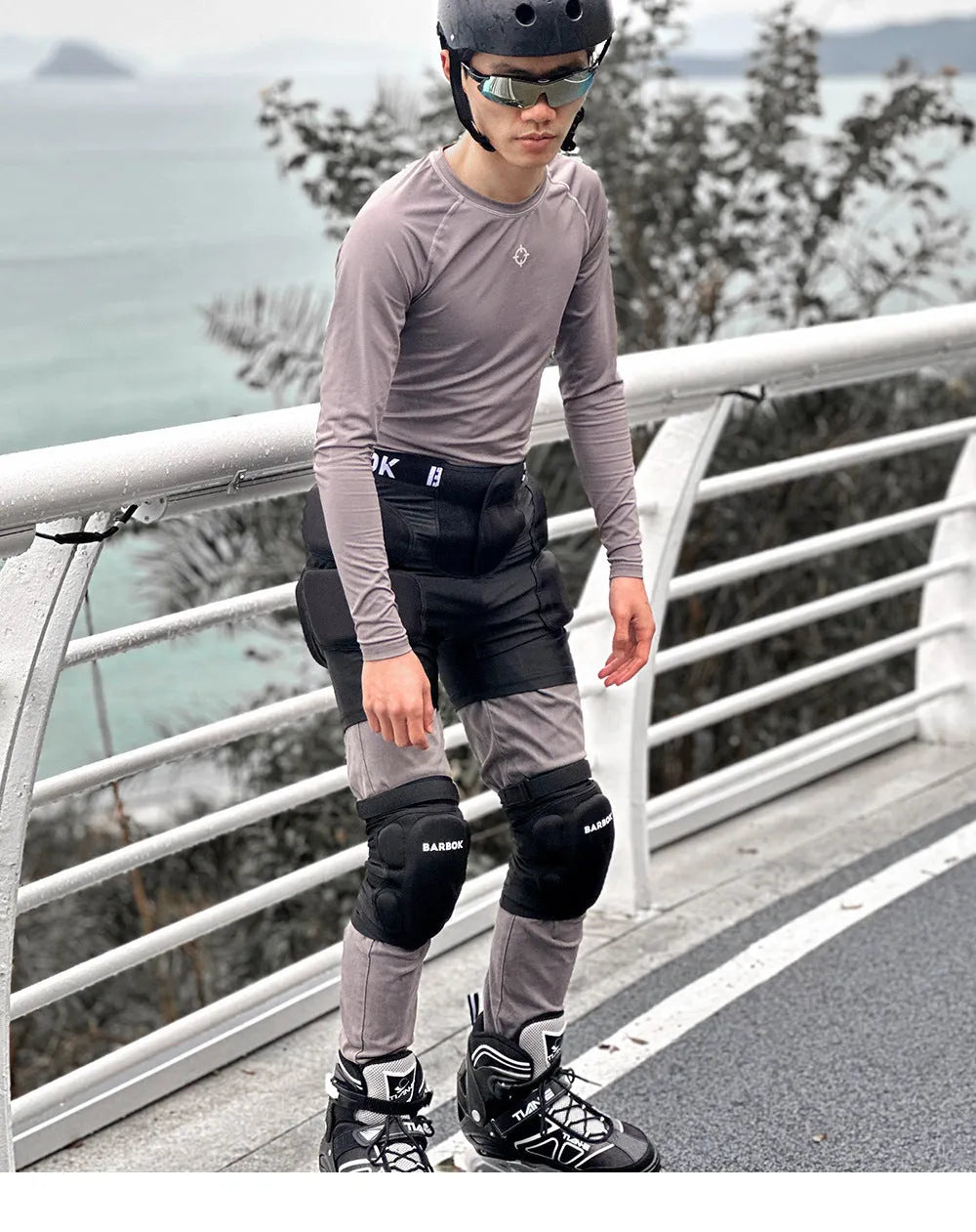 Black protective spandex trousers with integrated hip pads for skating and skateboard fall protection.