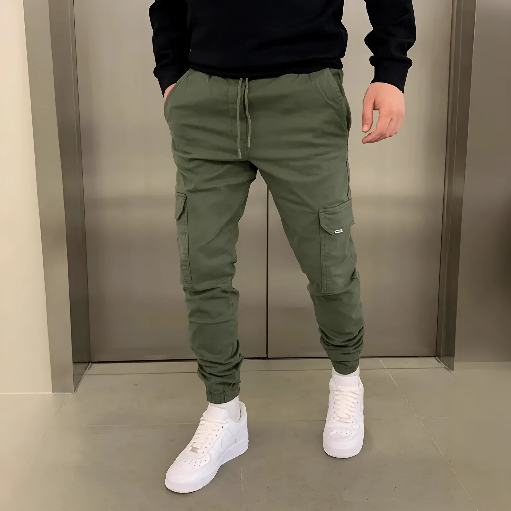 Men's loose-fit casual trousers with elastic waistband and patch pockets in army green colour