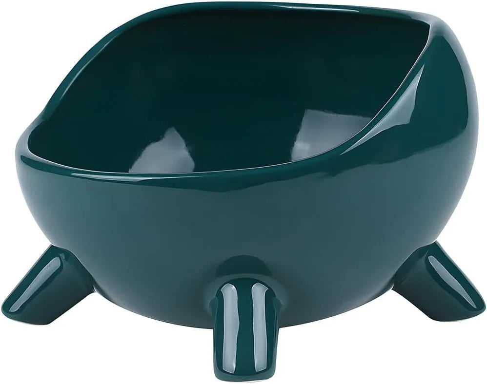 Green ceramic cat food bowl with four-leg stability base on wooden floor