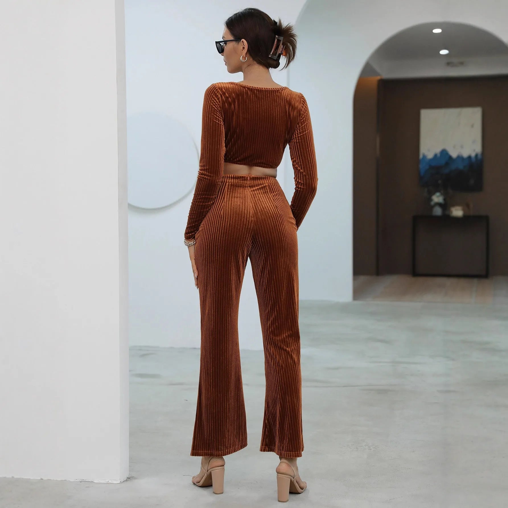 Caramel-coloured long sleeve sweater and trouser set on hanger