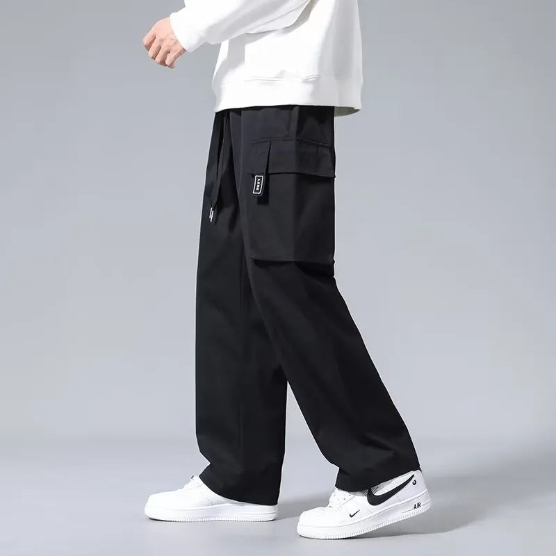 Boys in straight-leg cargo pants with drawstring waist and large side pockets, shown in army green.