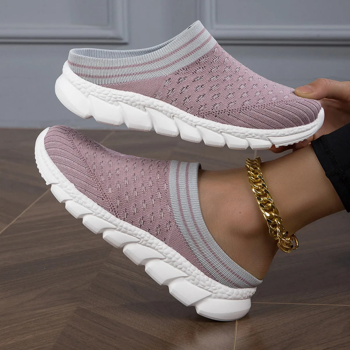 Women's black Flyknit slipper shoes with striped pattern and hollowed-out design on a viscose sole.