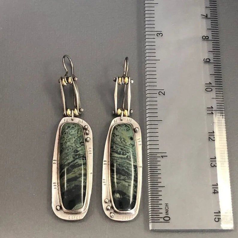 Two-tone geometric marble pattern drop earrings in alloy metal showing contrasting colours