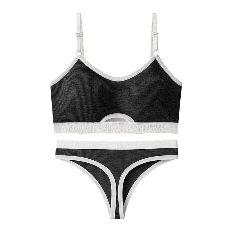 White sports underwear vest with contrast back detail and matching underwear, shown on a hanger.