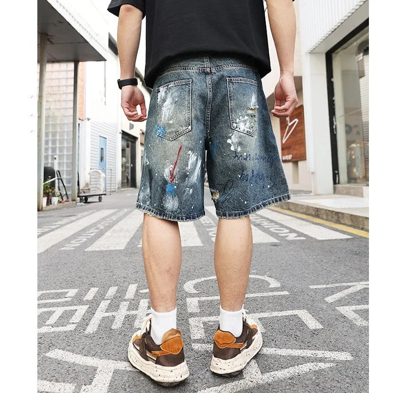 Blue ripped men's denim jeans shorts with a zip fly and straight-leg opening.