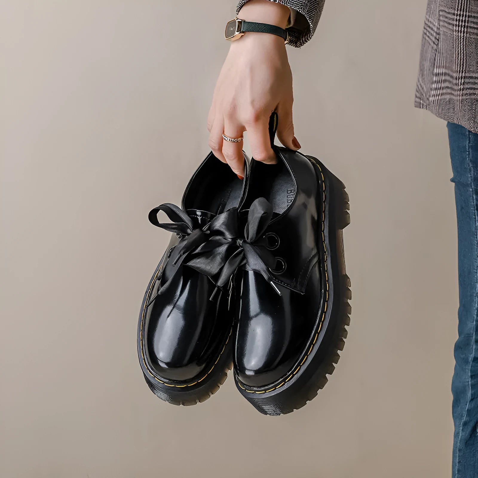 Women's black and white thick-soled leather shoes with lace-up closure and decorative straps