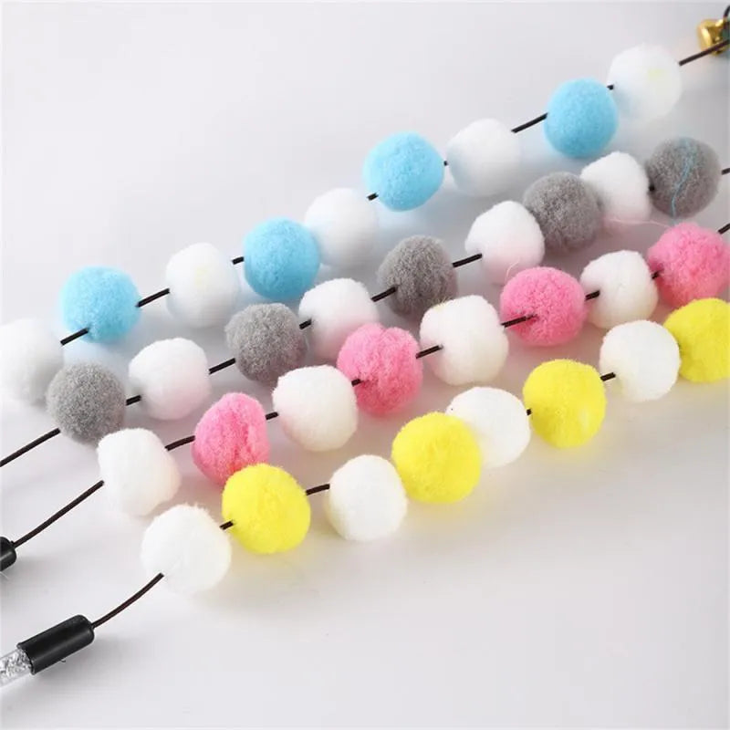 Set of four colourful cat teaser toy rods with feathers, pompons and bells.