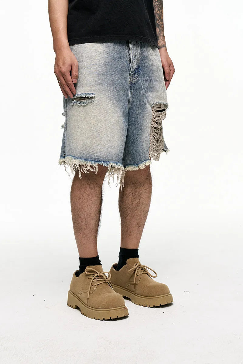 Light blue men's baggy denim shorts with a wide leg and mid waist on a plain background.