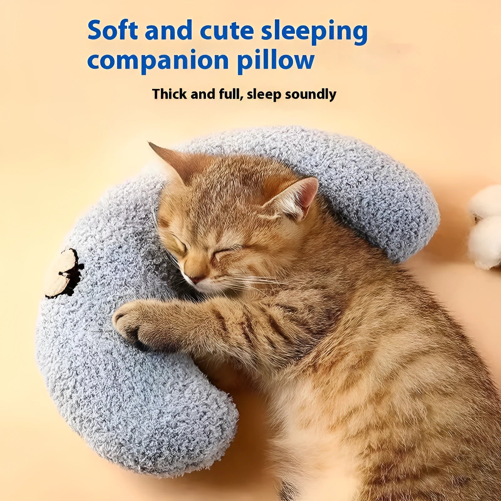 Blue question mark shaped cloth pillow for cat neck support on a pet sleeping mat
