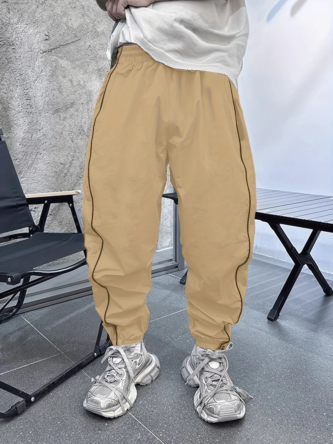 Men's blue bamboo fibre cropped sports trousers with a loose casual fit on a hanger.