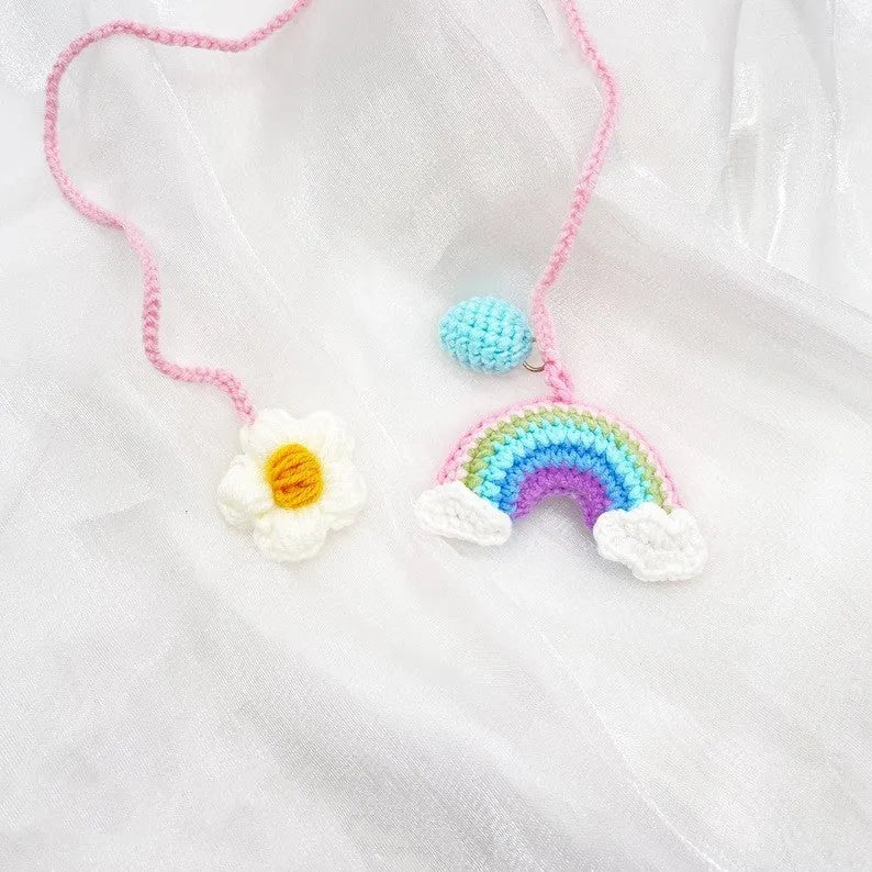 Handmade crocheted wool car pendant with rainbow colours hanging from car mirror