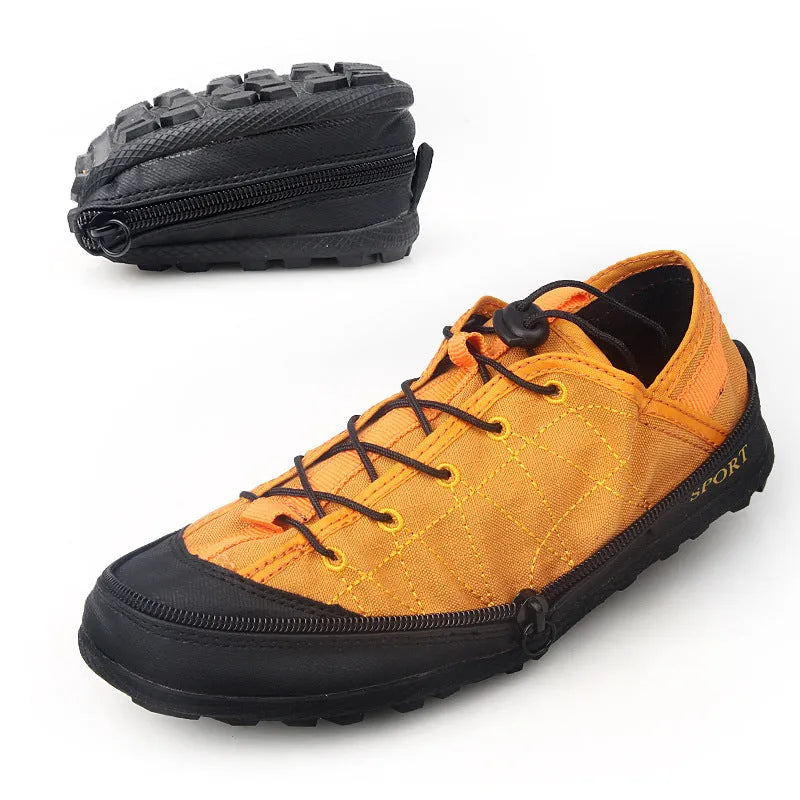 Orange portable folding outdoor hiking shoe with side zipper on a grey background.