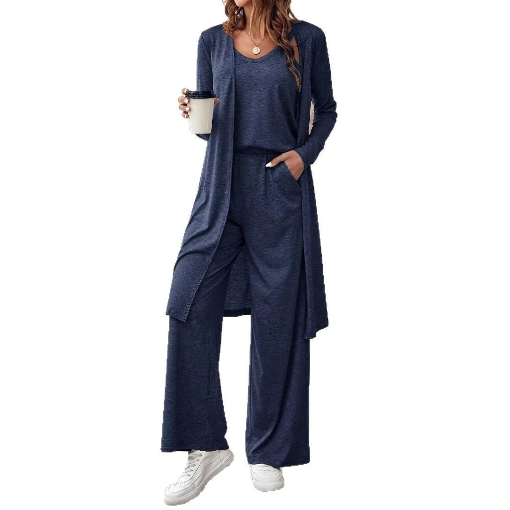 Blue women's two piece casual suit with long sleeve top, trousers, and suspenders on a hanger.