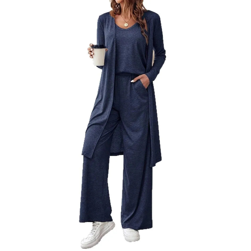 Blue women's two piece casual suit with long sleeve top, trousers, and suspenders on a hanger.