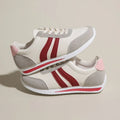 A pair of blue low-top lace-up running sneakers with a round toe and soft rubber sole on a white background.