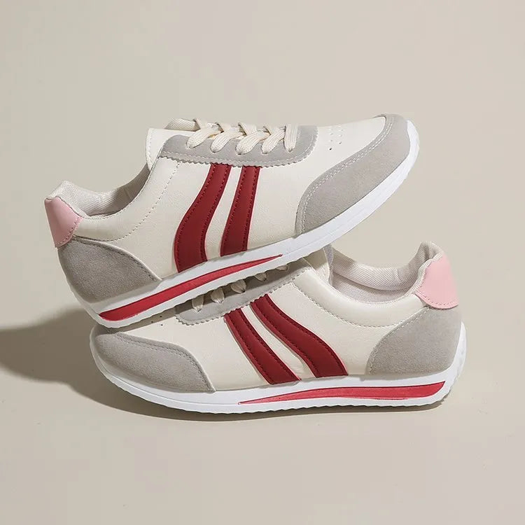 A pair of blue low-top lace-up running sneakers with a round toe and soft rubber sole on a white background.
