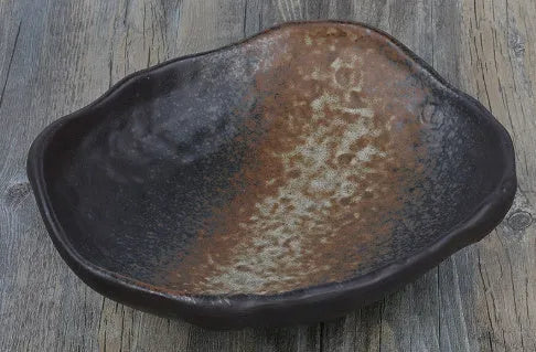 Japanese ceramic sashimi bowl with irregular shape and floral decoration pattern