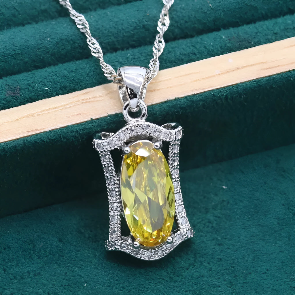 Yellow zircon jewellery set showing necklace with snake bones chain, matching earrings, ring, and bracelet on a white background.