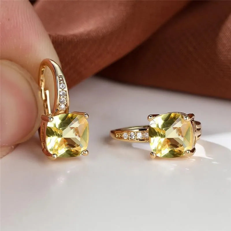 Square geometric ear hook earrings with zircon stones in an electroplated copper setting.