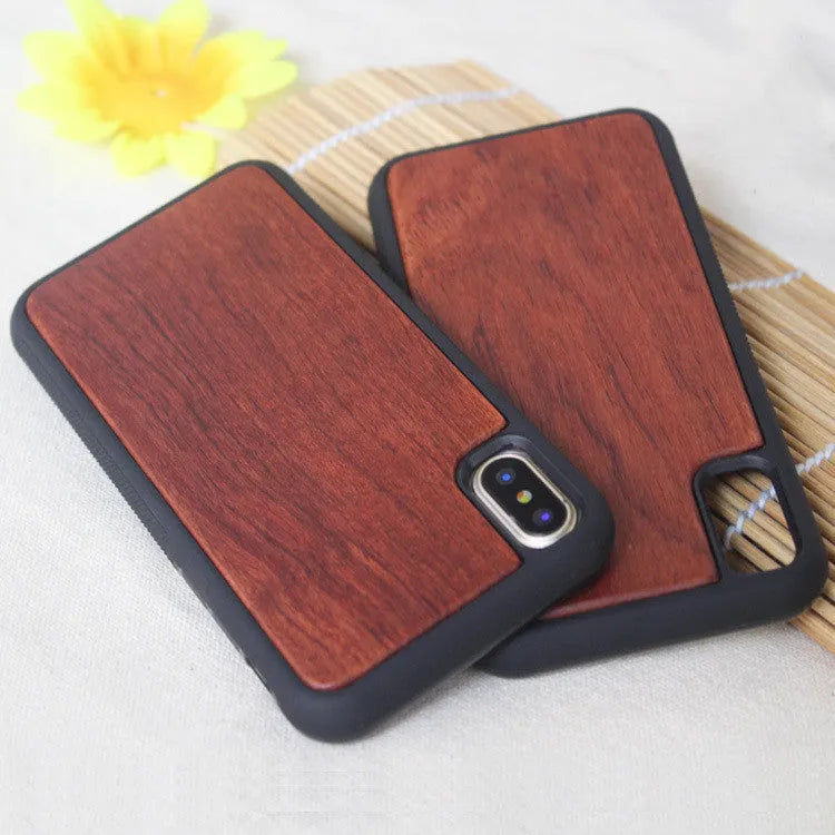 Wooden carbonised bamboo and black TPU bumper case for iPhone on a wooden table.