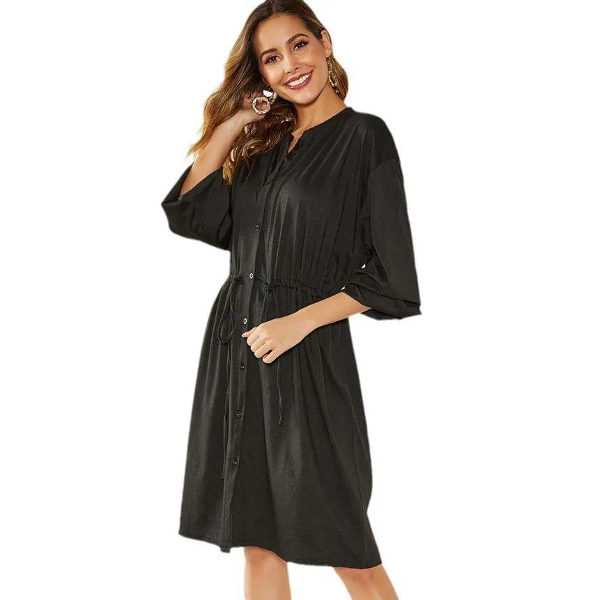 Women's black A-line midi dress with cinched waist belt and long sleeves on hanger