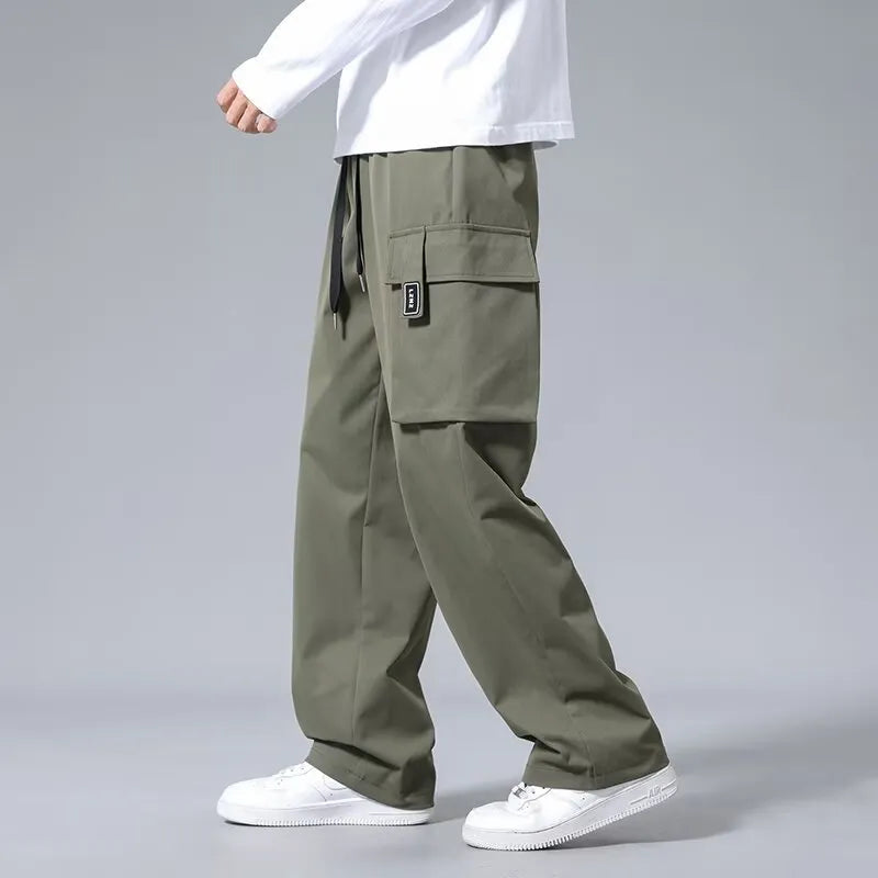Boys in straight-leg cargo pants with drawstring waist and large side pockets, shown in army green.