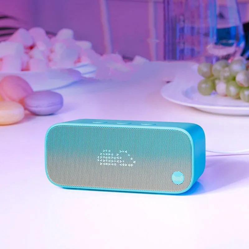 Compact Elf sugar cube AI smart WiFi speaker in blue colour on a wooden shelf