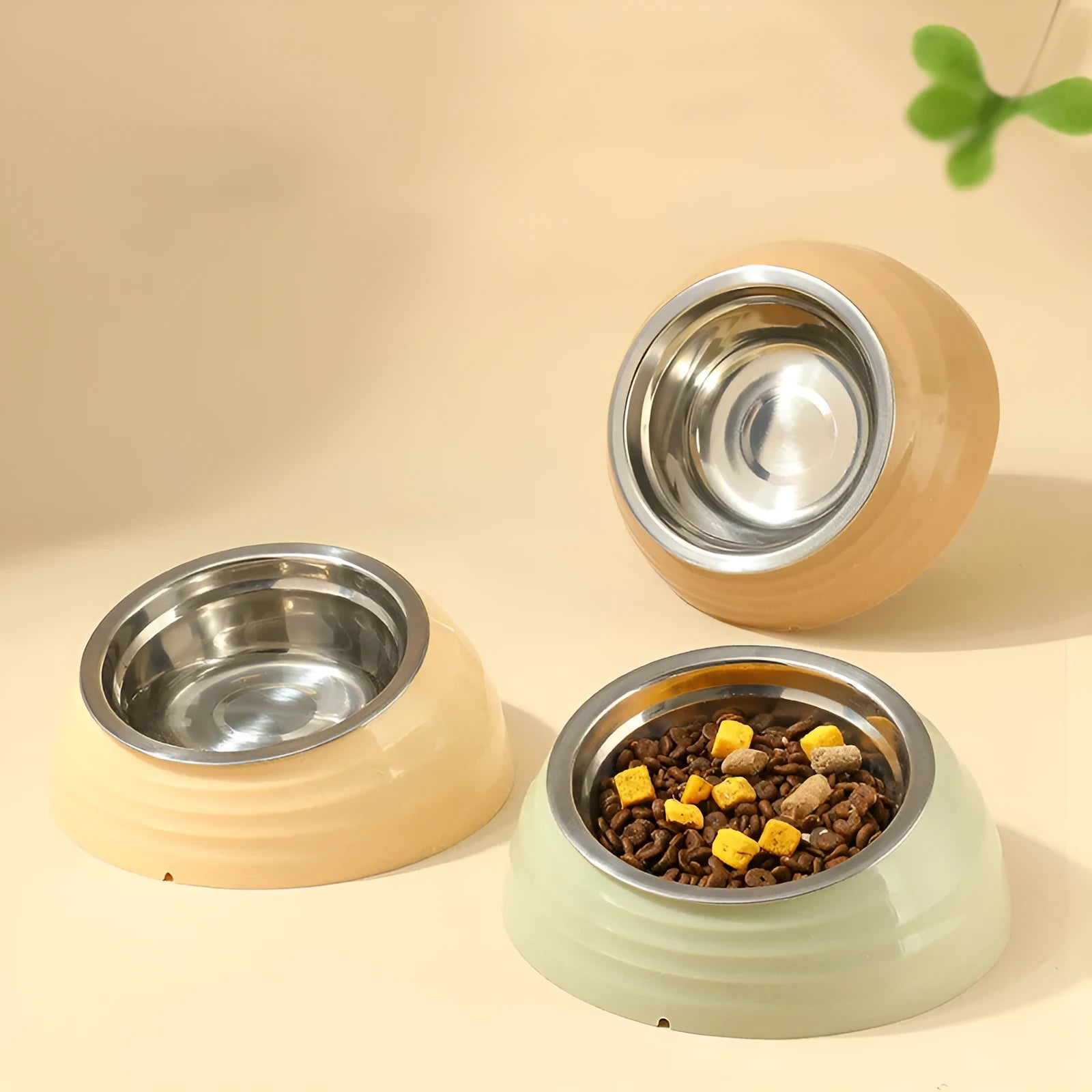 Stainless steel cat bowl with plastic base in beige, brown, or light green.