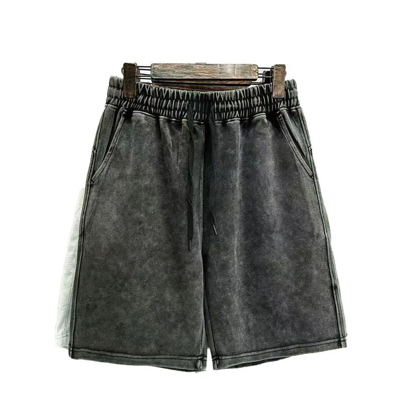 Men's light blue cotton shorts with distressed detailing and a loose, straight-leg fit on a mannequin.