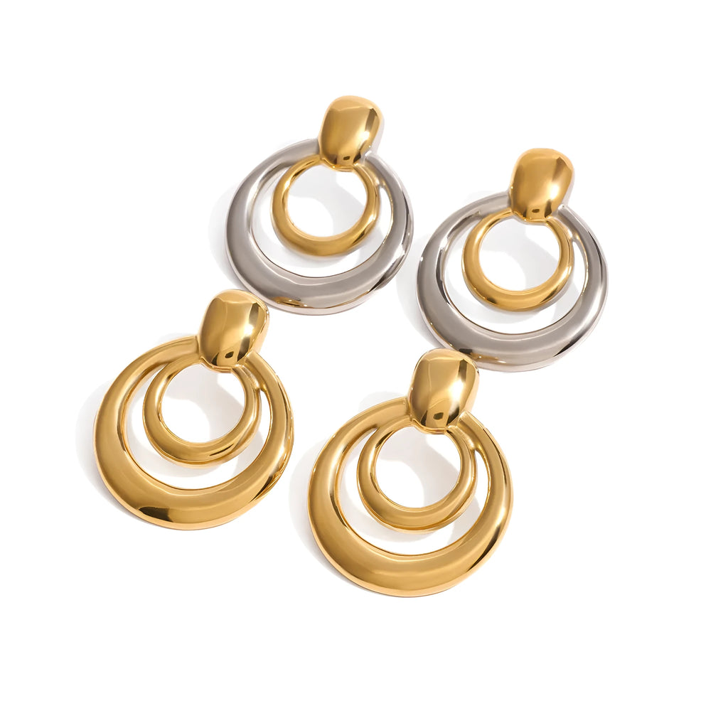 Round gold-coloured geometric hollow stud earrings on a white background.
