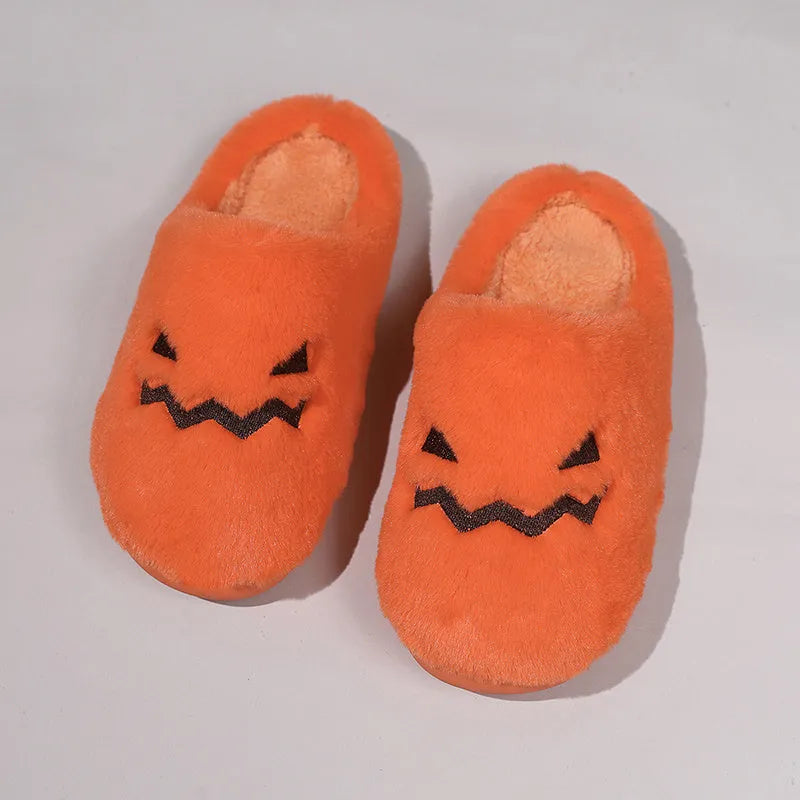 Orange Halloween pumpkin themed slippers with coral velvet upper and plush lining on a flat PVC sole.